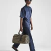 Bolso de viaje grande de tela con el símbolo de Prada bordado Bolso de viaje grande de tela con el símbolo de Prada bordado