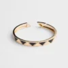 Brazalete Eternal Gold en oro amarillo con elementos de cerámica Brazalete Eternal Gold en oro amarillo con elementos de cerámica