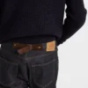 Pantalones de mezclilla sin tratar con tira de cuero Pantalones de mezclilla sin tratar con tira de cuero