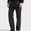 Pantalones de mezclilla sin tratar con tira de cuero Pantalones de mezclilla sin tratar con tira de cuero